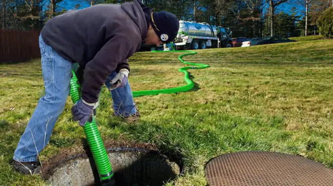 Service technician performing residential septic pumping and drainage maintenance in Columbia, MO